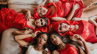 Overhead shot of five fashion models wearing red garments from designer Cardiovascuwhore.