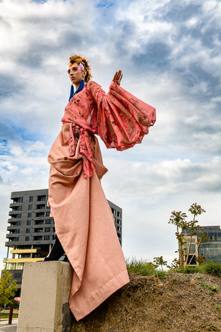 Fashion model wearing flowing coral top by Sky Barker Maa.