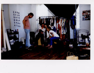 Polaroid of the ShowHaus team looking at the back of a digital camera.